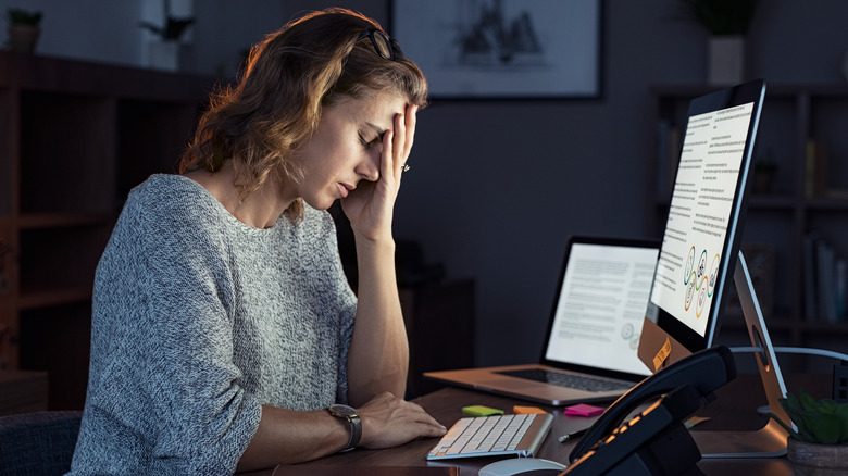 woman feeling tired after working on computer